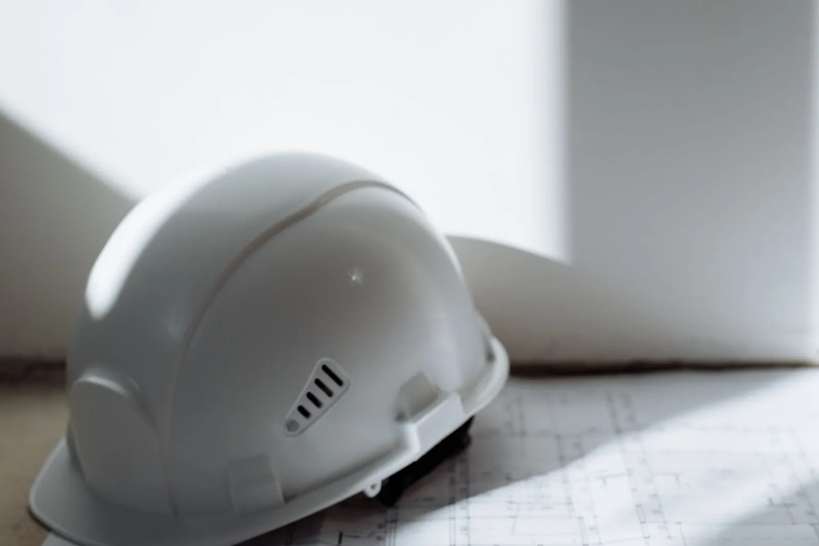 Hard hat on construction floor plans