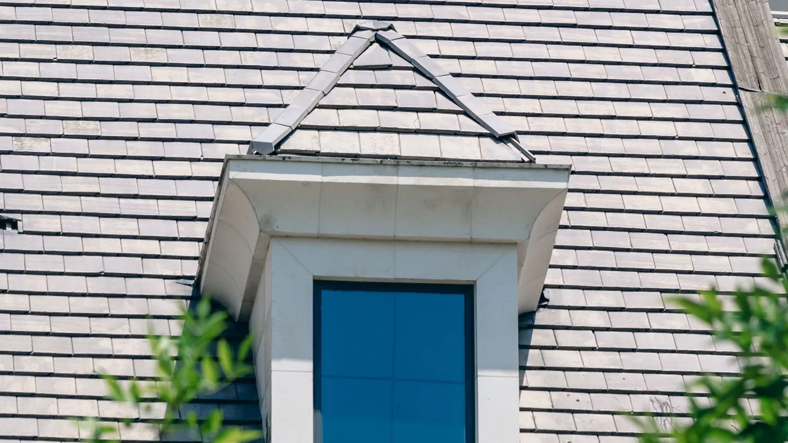 What an FHA loan costs, from down payment to closing Gray shingled roof and white dormer window of a Cape style home, illustrating the cost of an FHA loan