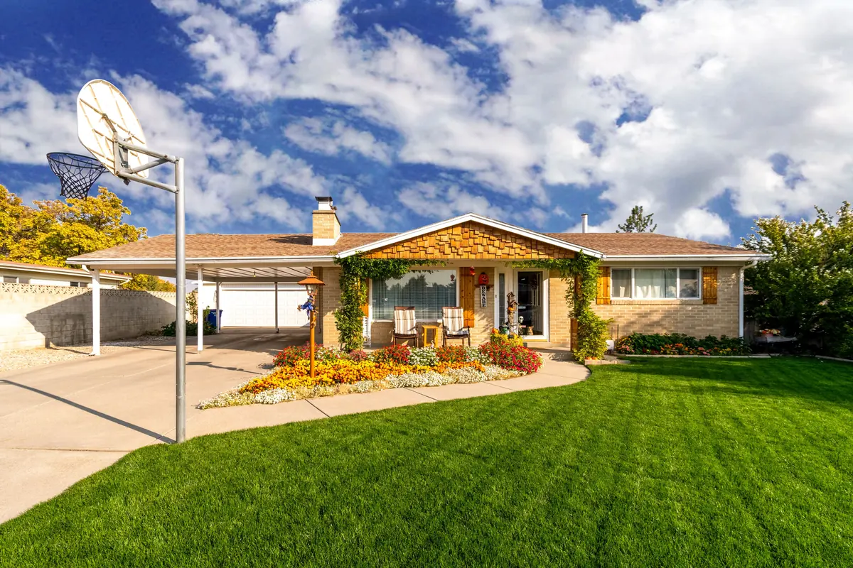 A clean single-story ranch home with intact windows, mowed lawn, and flower beds — a bank-owned home that could meet VA minimum property requirements after normal repairs
