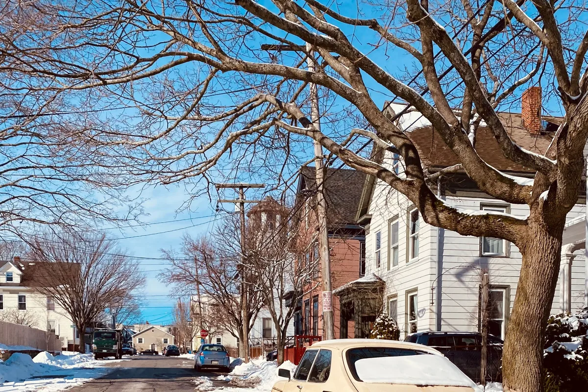 A Portland, Maine peninsula street lined with older multi-family houses, for a guide to DSCR loans in Portland
