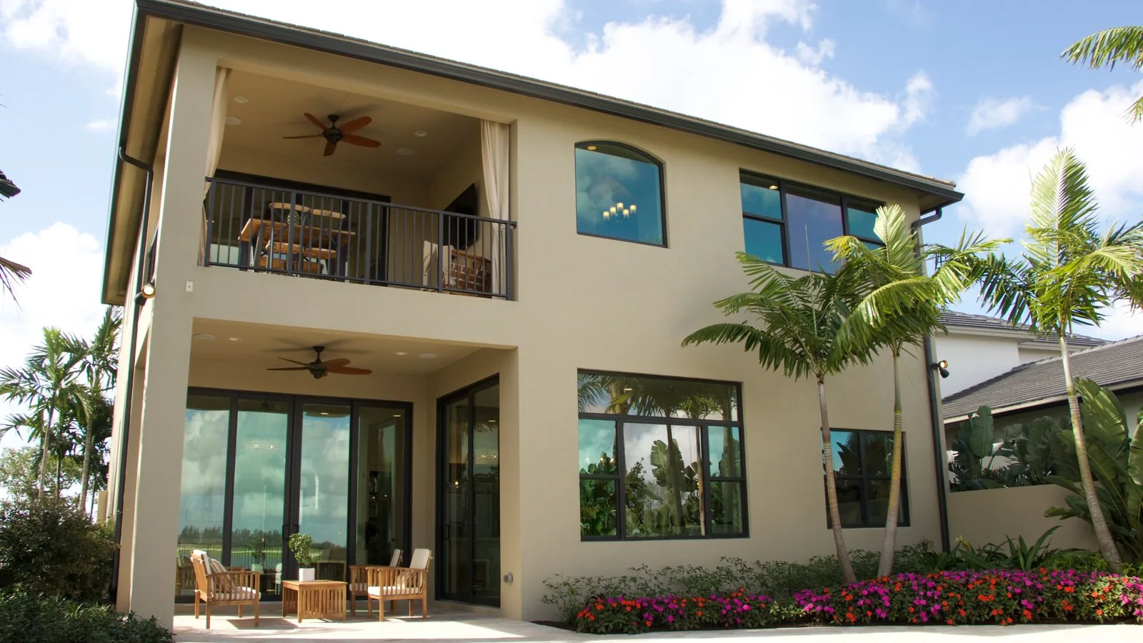 Florida stucco home with lanai and palm trees