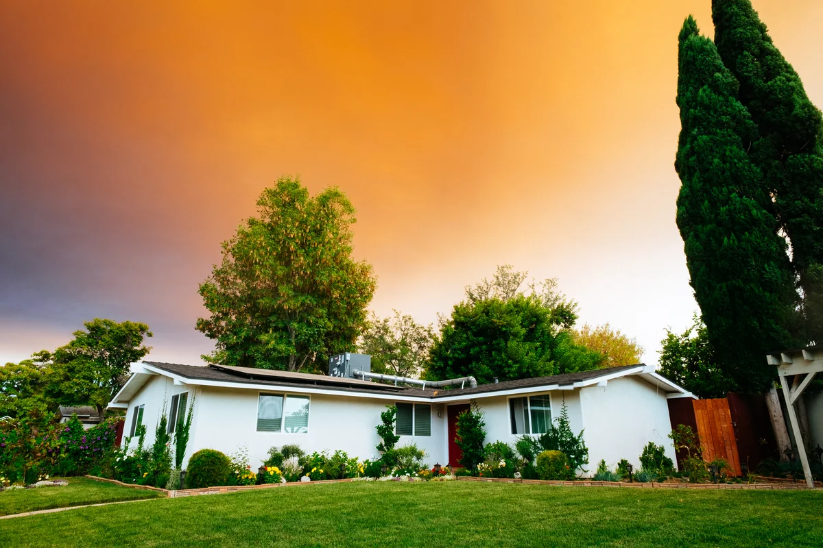 A single-story suburban ranch house with a green front lawn, for a guide to how many FHA loans you can have