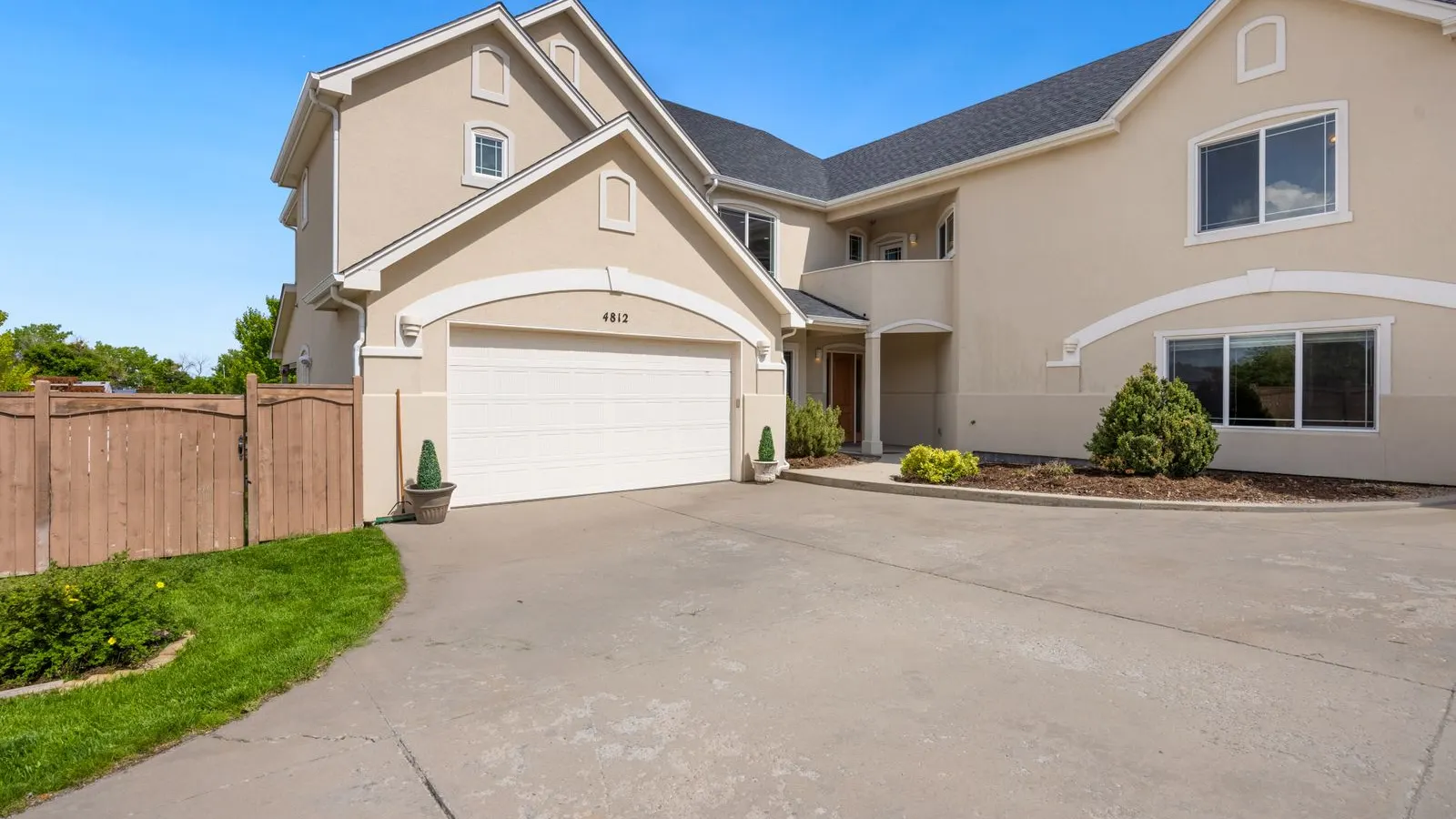 Tan two story home with a double garage