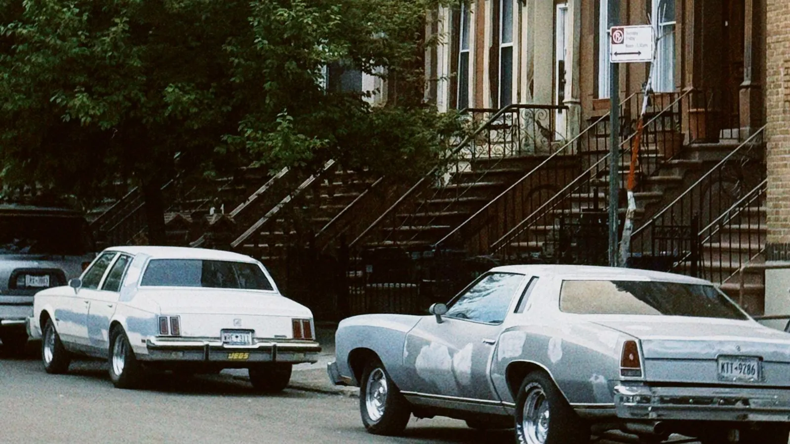 Brownstones and parked classic cars on a Brooklyn street