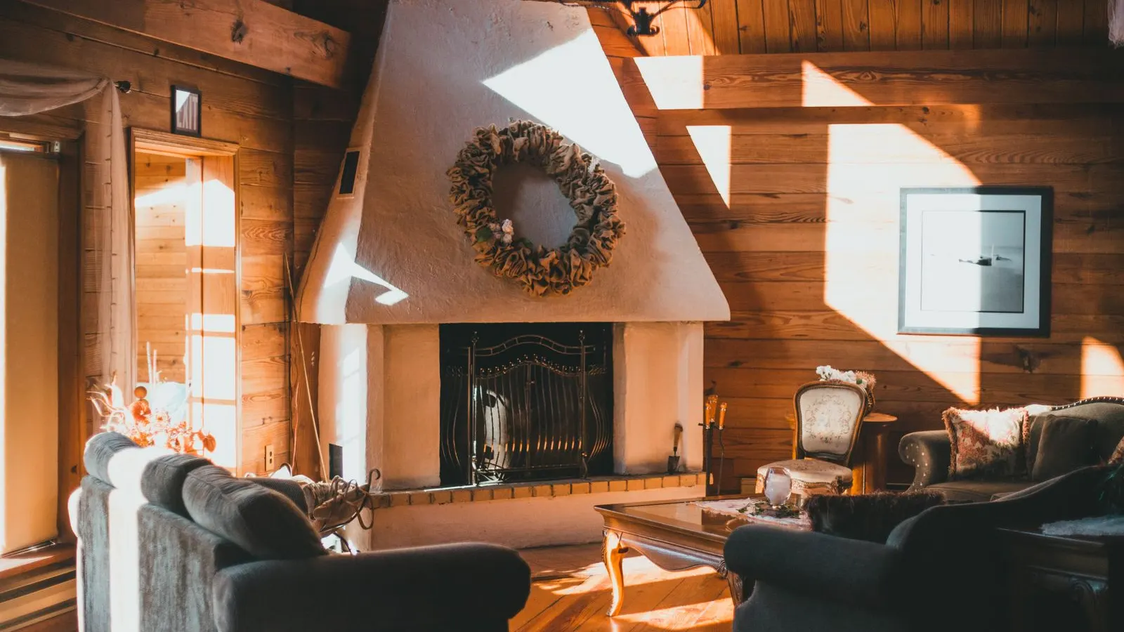 Cabin living room with a fireplace and afternoon sun