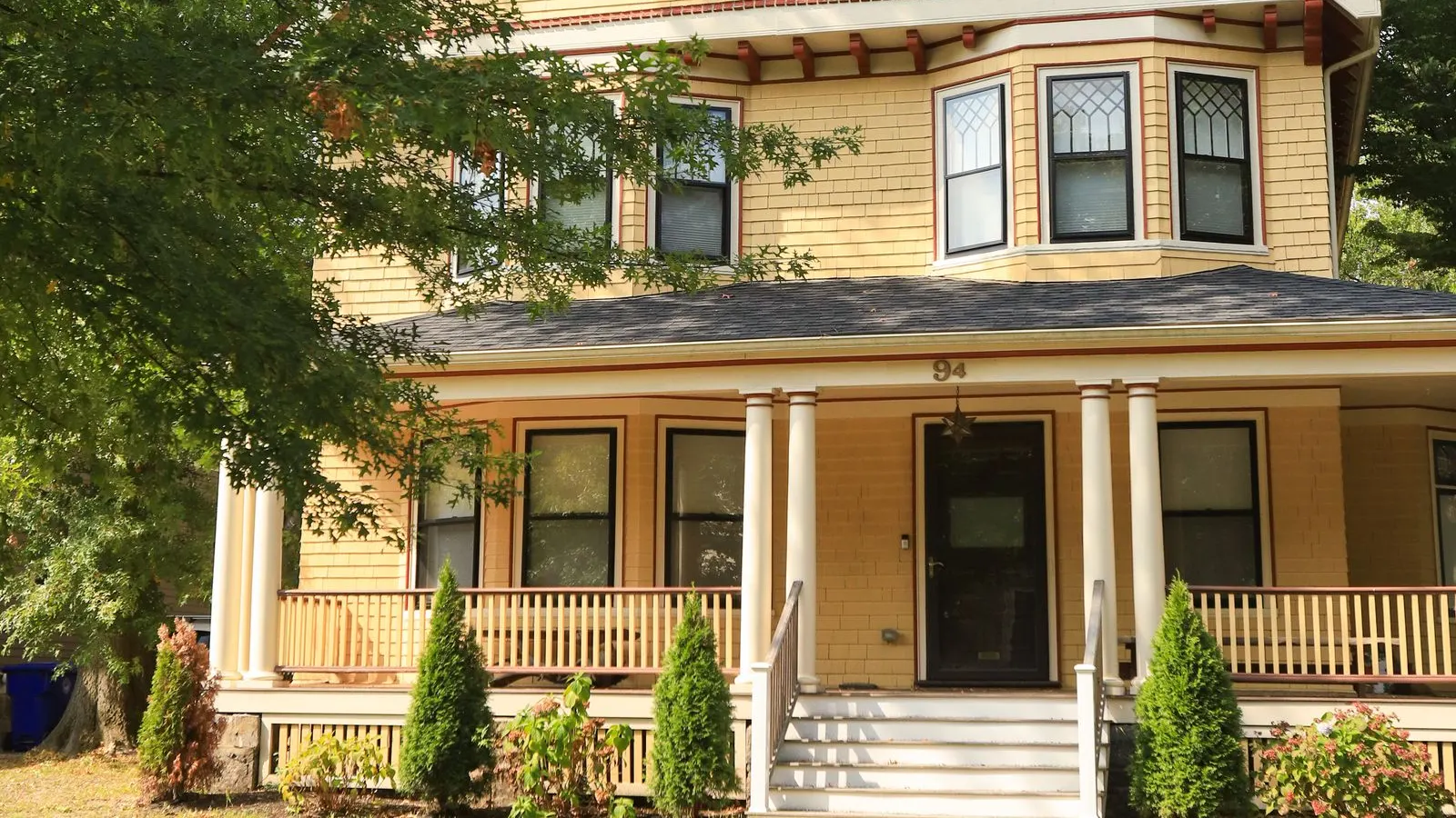 Yellow Victorian house with a wide front porch