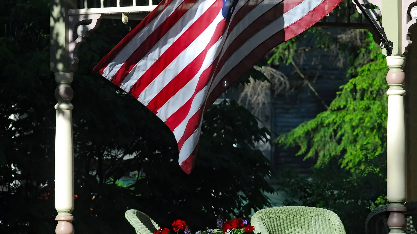 American flag on a porch with flowers