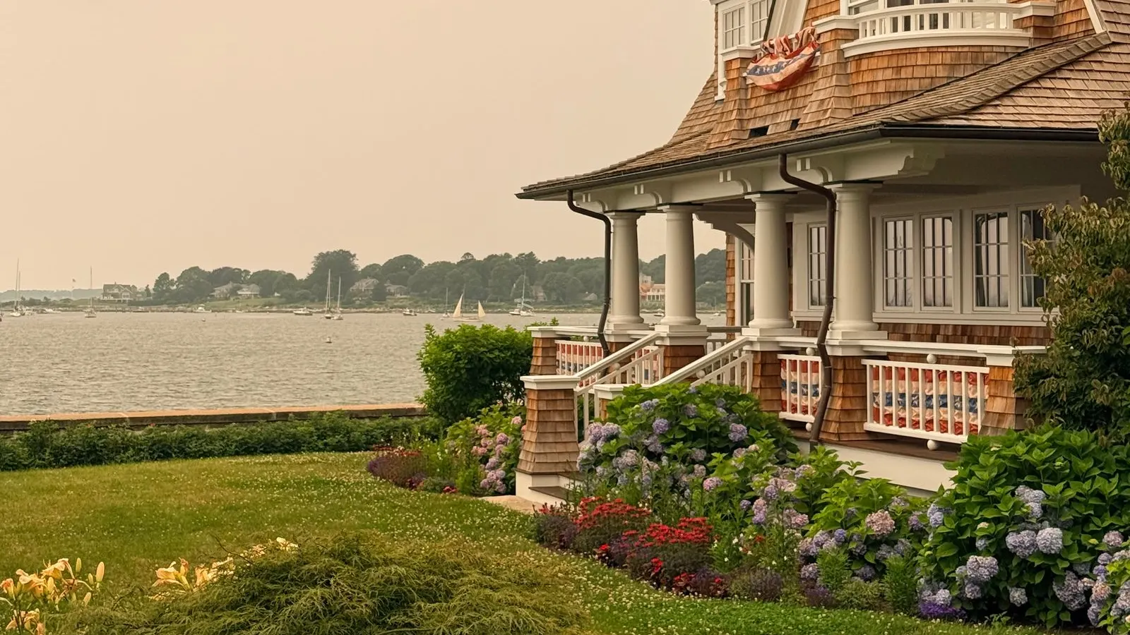 Shingled coastal cottage above the water