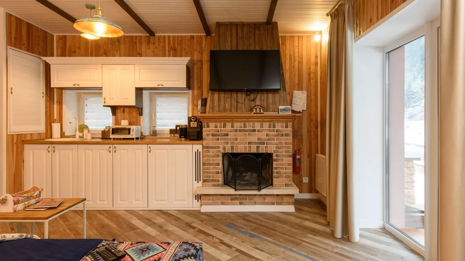 Bright wood paneled living room with a stone fireplace