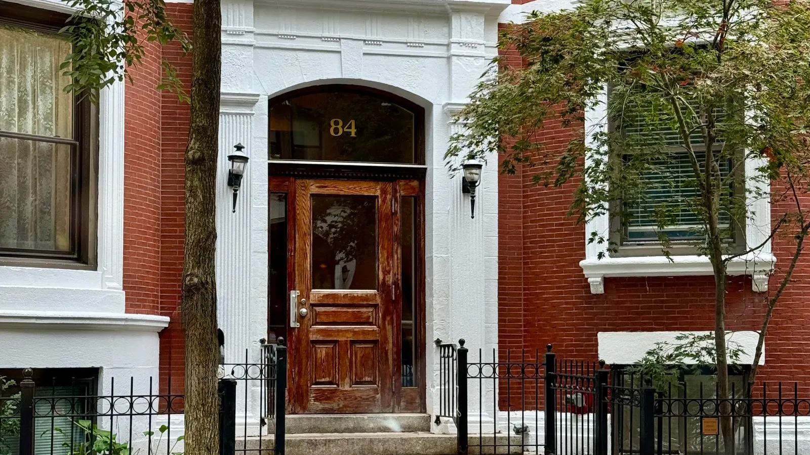 Brick townhouse entry with a dark wood door in Boston