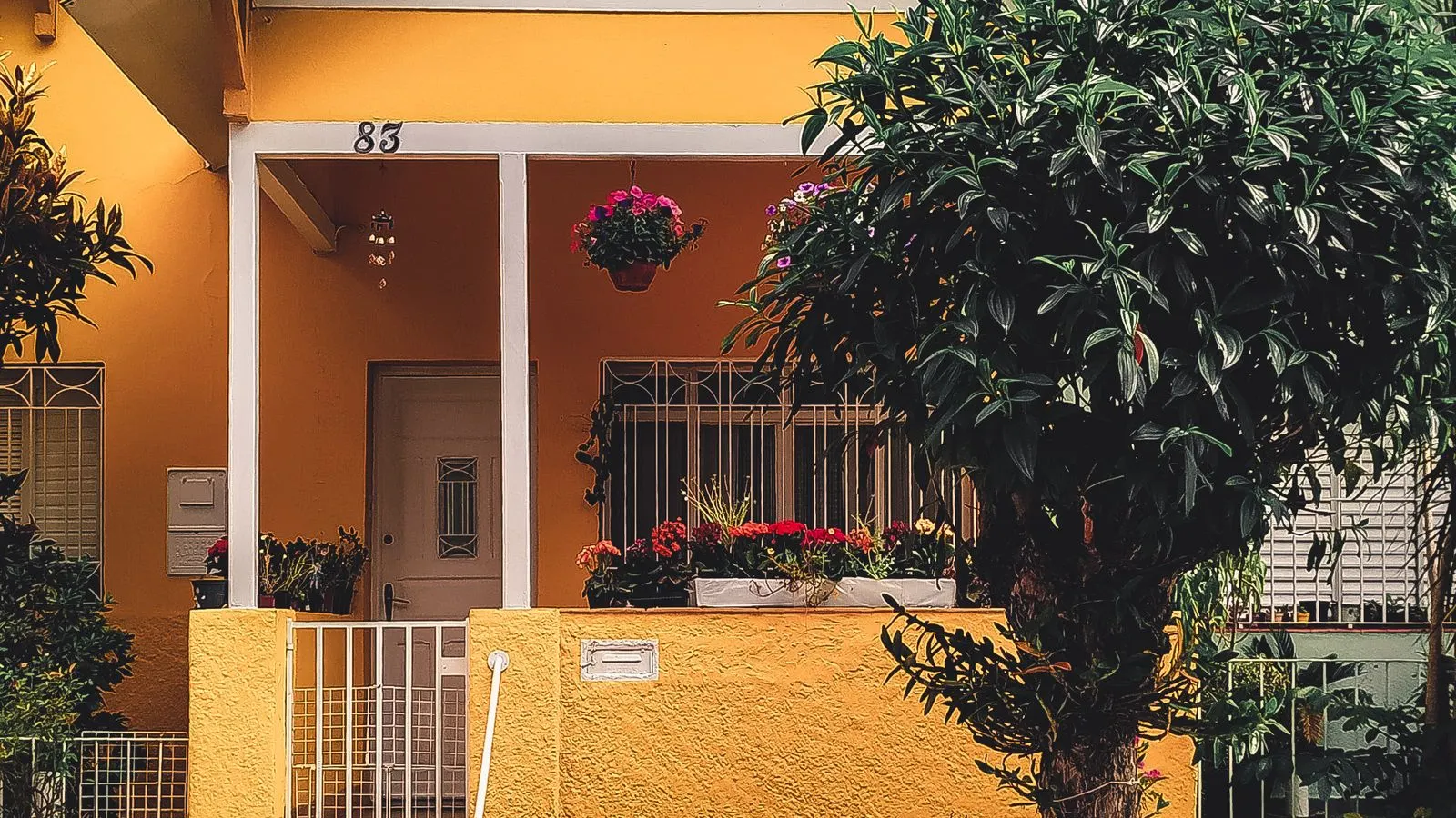 Yellow house with a covered front porch and garden