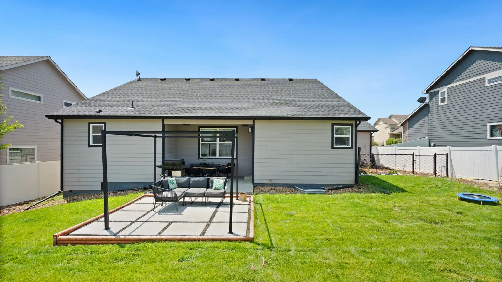 Single story home with a covered patio and lawn