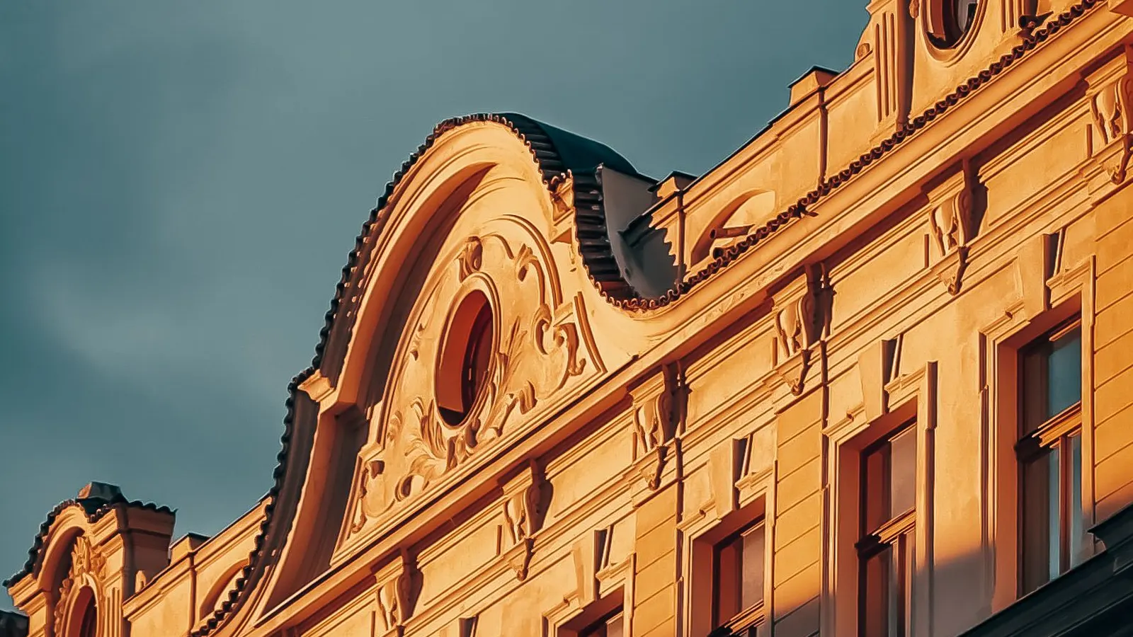 Ornate brick apartment building in Pittsburgh lit by late sun