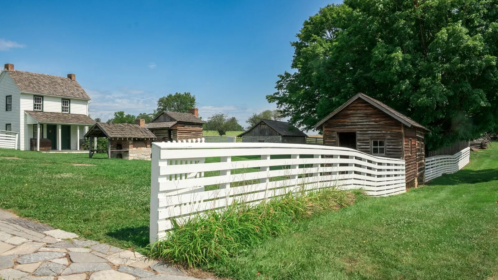 Historic farmhouse with white board fences