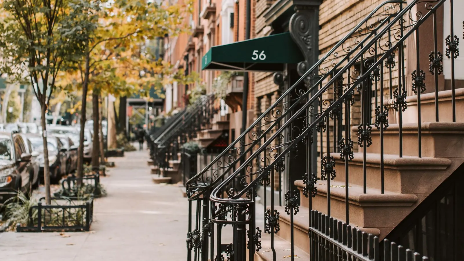 Brownstone stoops along a New York sidewalk