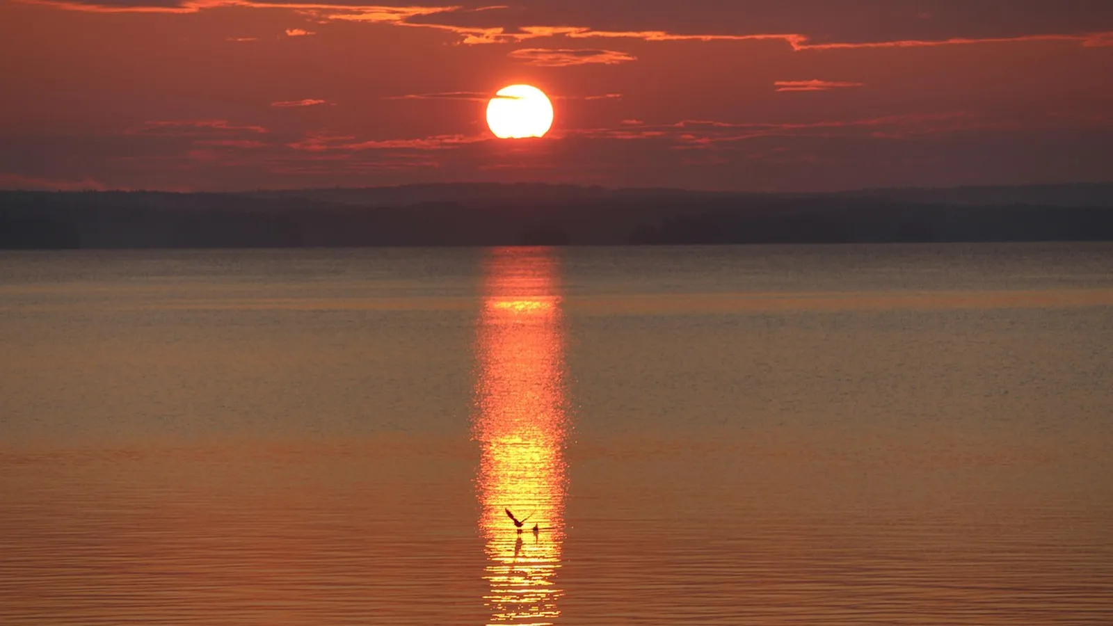 Sun setting over the open water of Sebago Lake, Maine