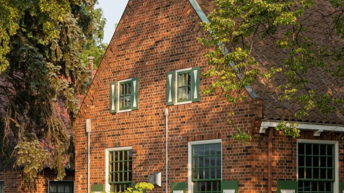 Red brick house with green shutters in Holland, Michigan