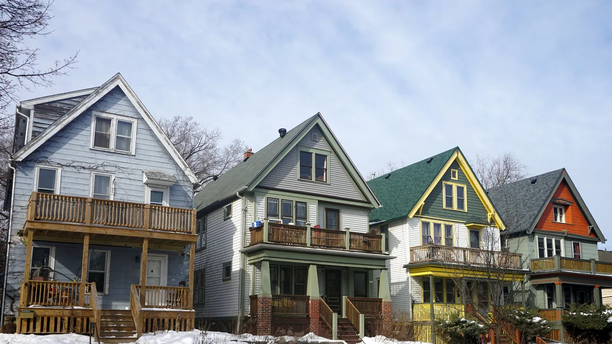 Row of frame duplexes with upper porches on North Fratney Street in Milwaukee, Wisconsin