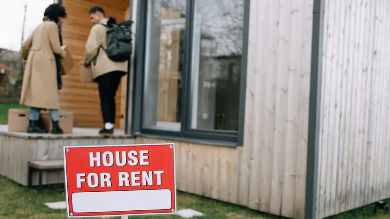 House for rent sign in front of a rental home