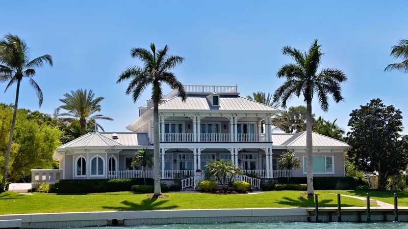 Two story Florida home with palm trees